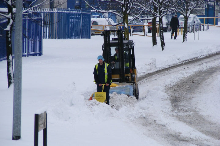 Construction workers clearing snow.