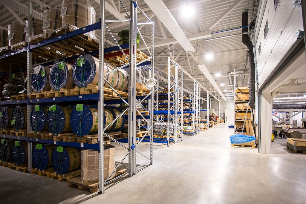 A factory with rows of barrels on shelves.