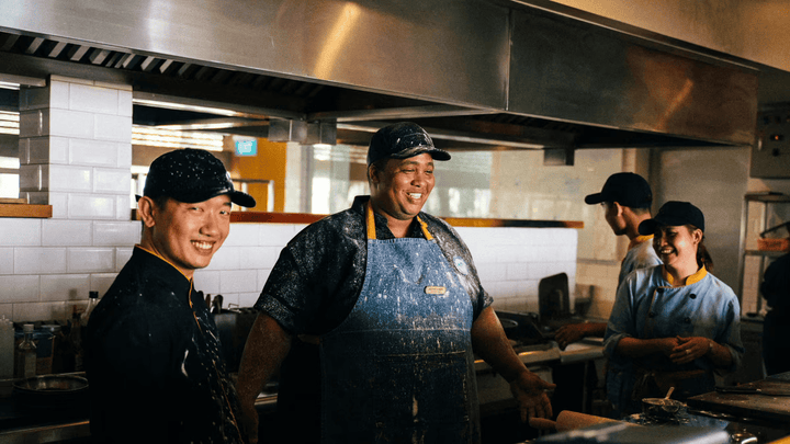Fast food workers with dough on their aprons.