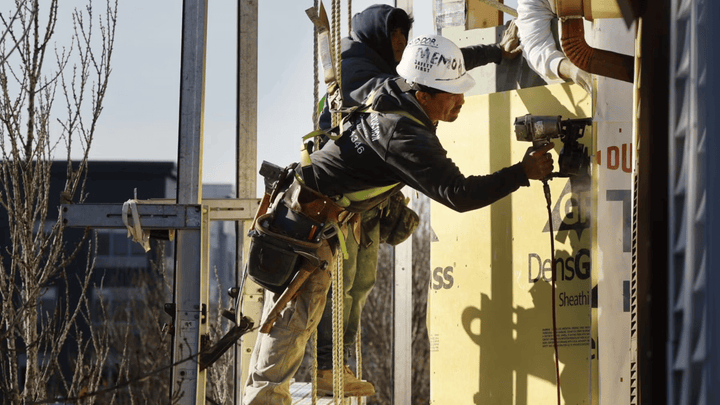 Construction worker using a nail gun.