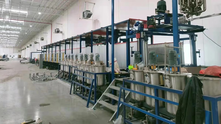 A factory with steel tanks of liquid.