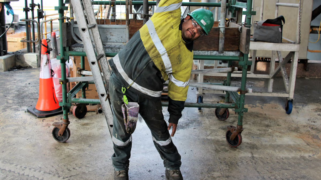 A construction worker stretching 