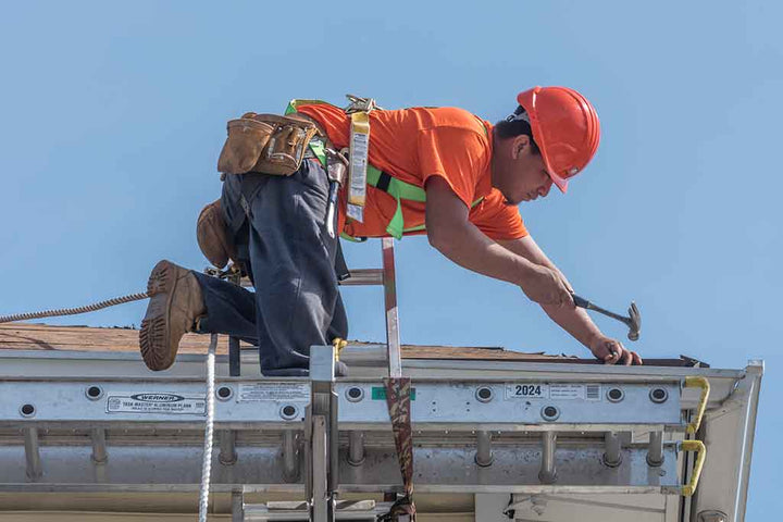Construction worker hammering a nail.