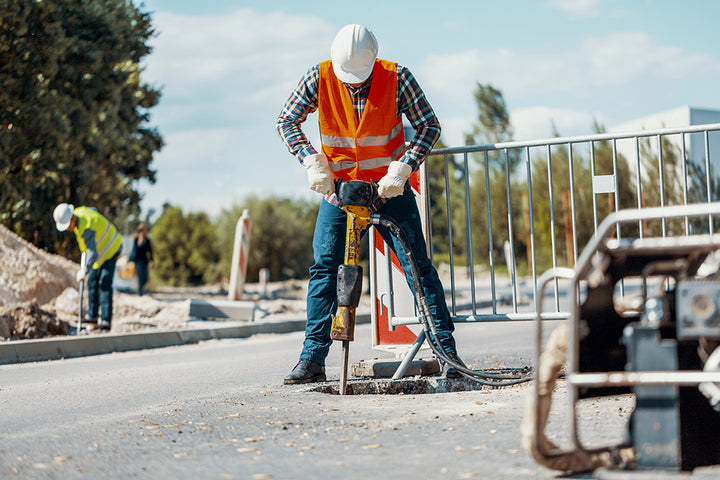 Construction worker using a jackhammer.