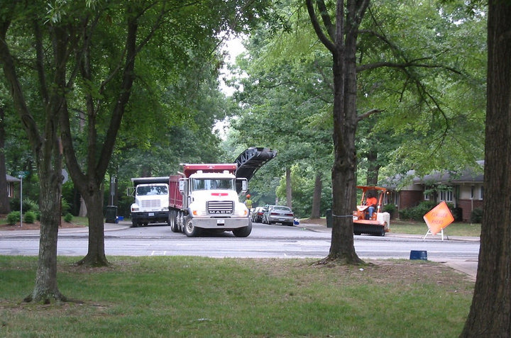 Construction trucks in a residential neighborhood.